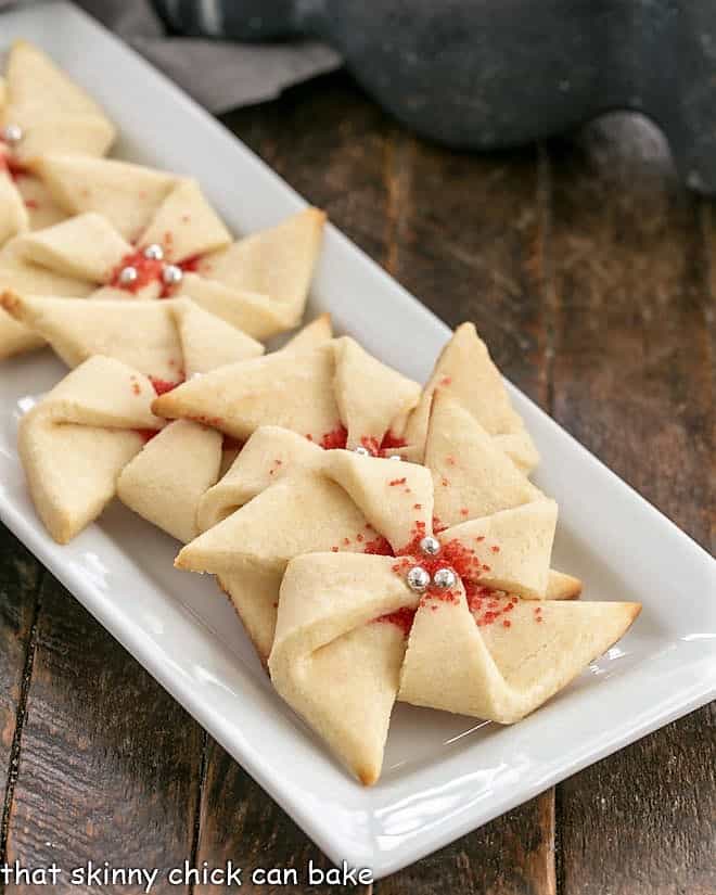 Poinsettia Cookies on a narrow white ceramic tray.