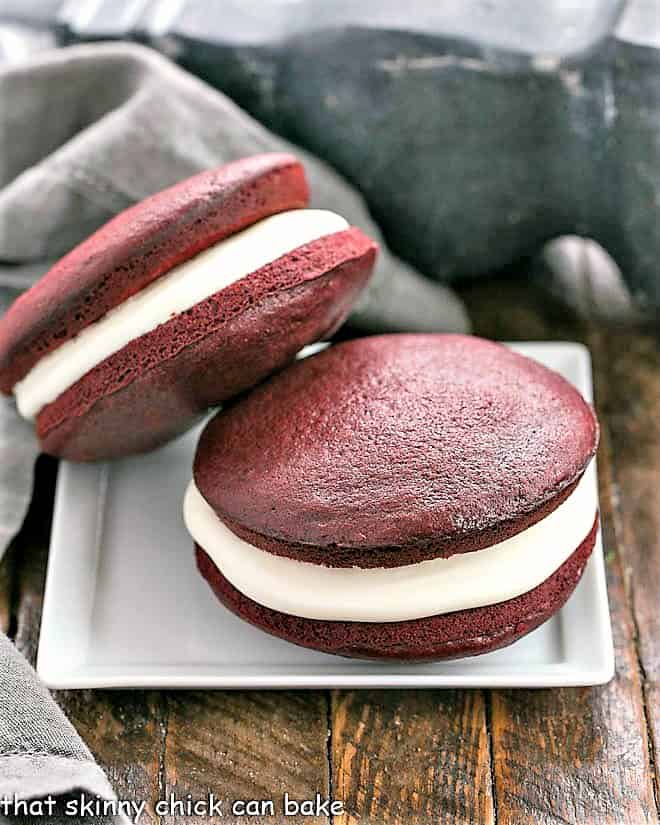 Two whoopie pies stacked on a square white plate