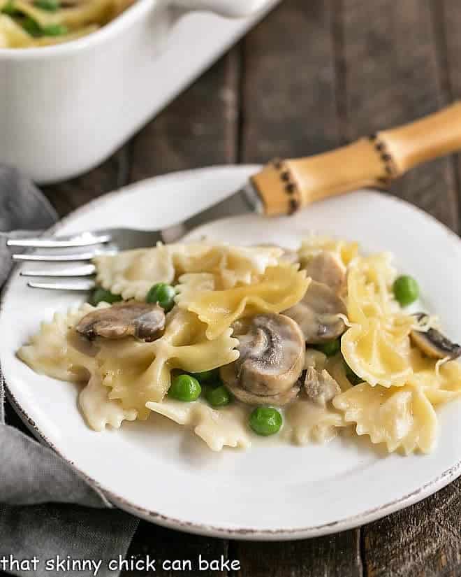 Turkey Tetrazzini on a white plate with a bamboo handle fork.