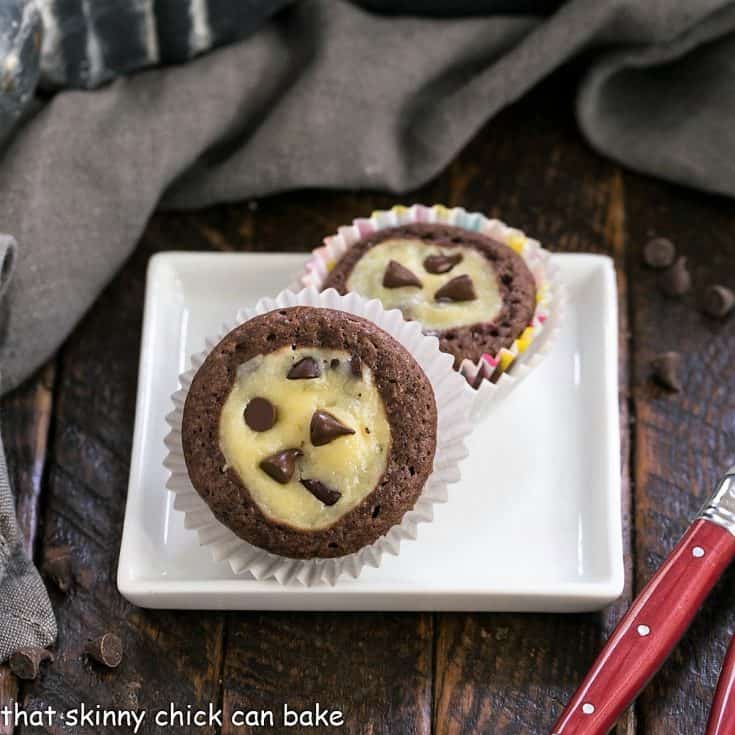 Two mini chocoate cupcakes on a square white plate