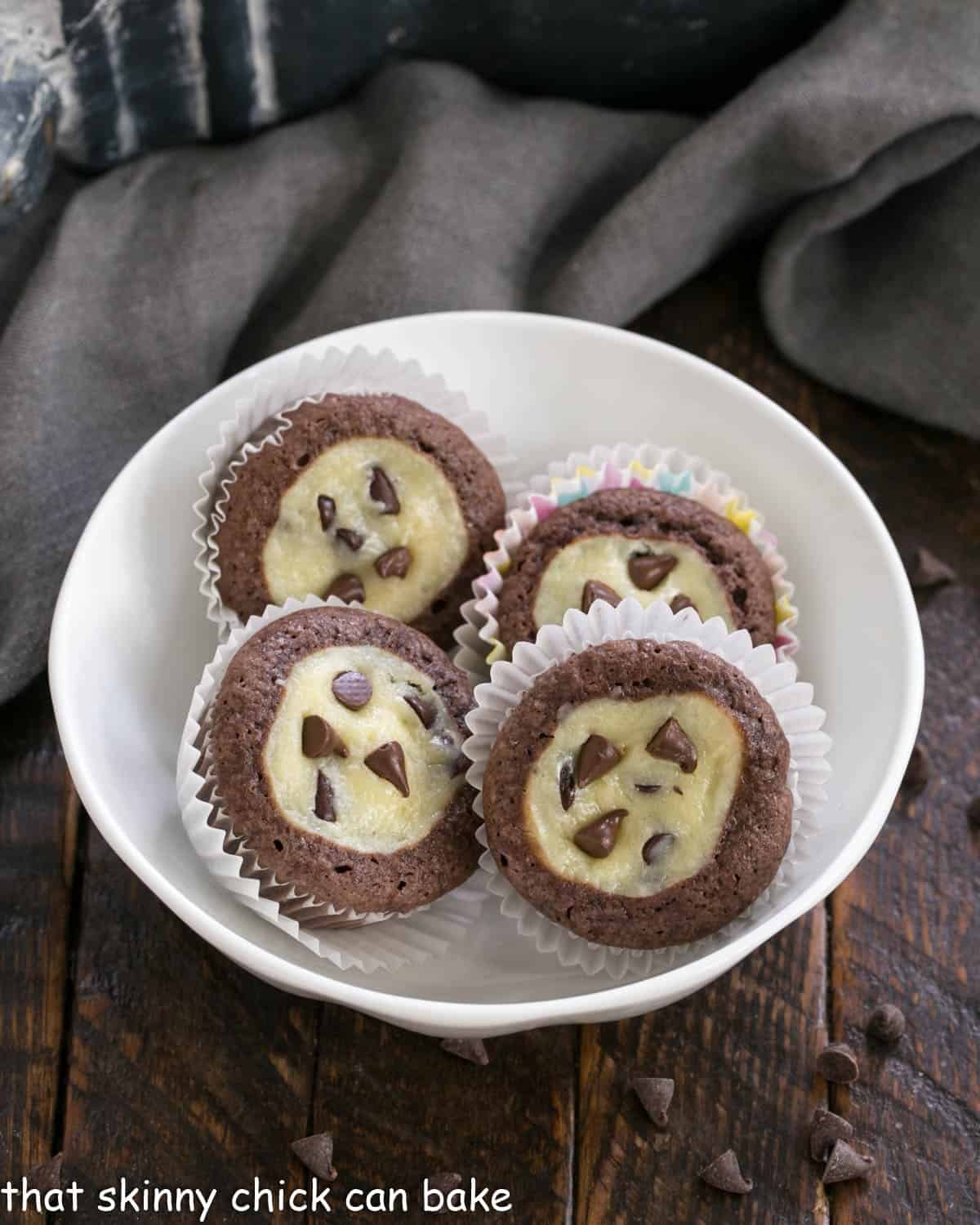 Mini chocolate cupcakes in a white bowl.