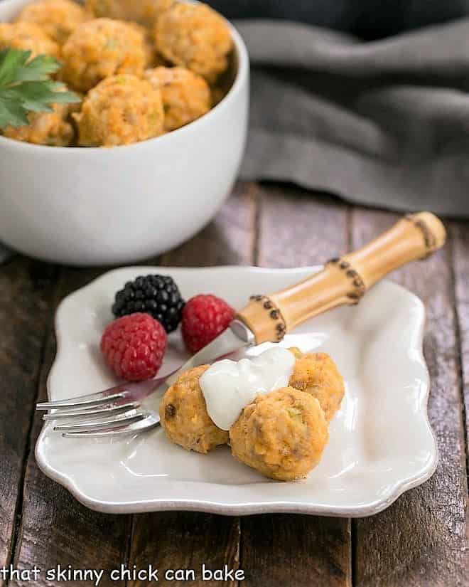 Buffalo chicken meatballs and berries on a white appetizer plate