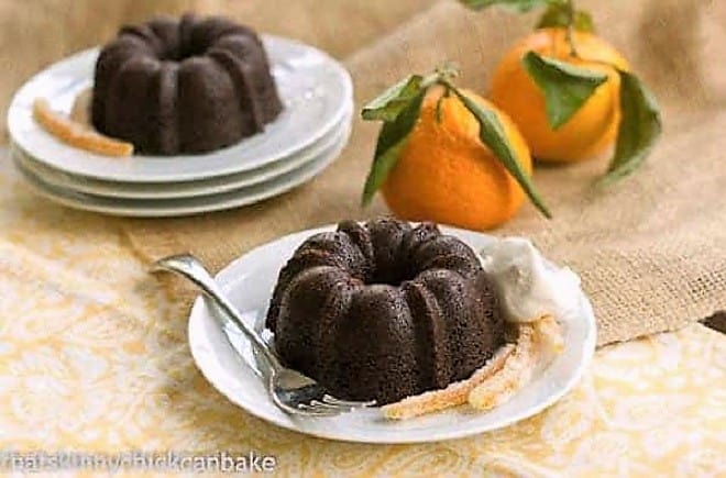 Mini Gingerbread Bundt Cakes on plates with candied orange peel