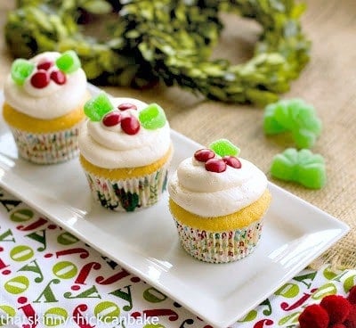 Holly Topped White Cupcakes on a white rectangular platter