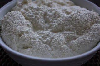 Homemade ricotta in a white bowl