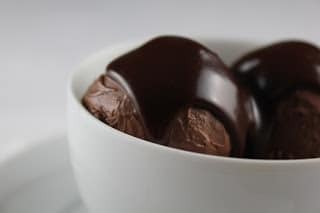 Chocolate Ice Cream with Fudge Sauce in a white bowl