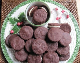 Overhead view of chocolate sandwich cookies on a holiday platter