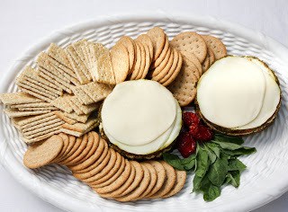 Overhead view of layered Italian dip on a tray with crackers