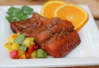 Overhead view Glazed Salmon with Fruit Salsa on a white plate.