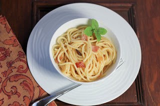 Overhead view of spaghetti carbonara in a white bowl