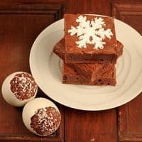 Stack of brownies on a white place next to egg shaped brownies in shells