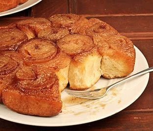 A plate partially eaten maple syrup sticky buns