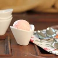 Small white bowl filled with strawberry mascarpone ice cream