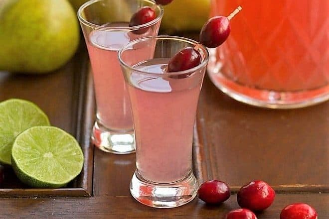 Pear Cosmopolitans in small glasses garnished with fresh cranberries