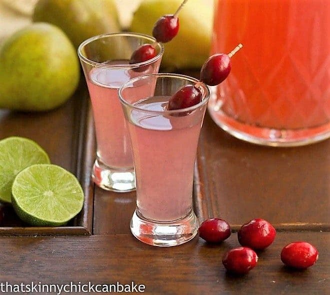 Pear Cosmopolitans in small glasses garnished with fresh cranberries