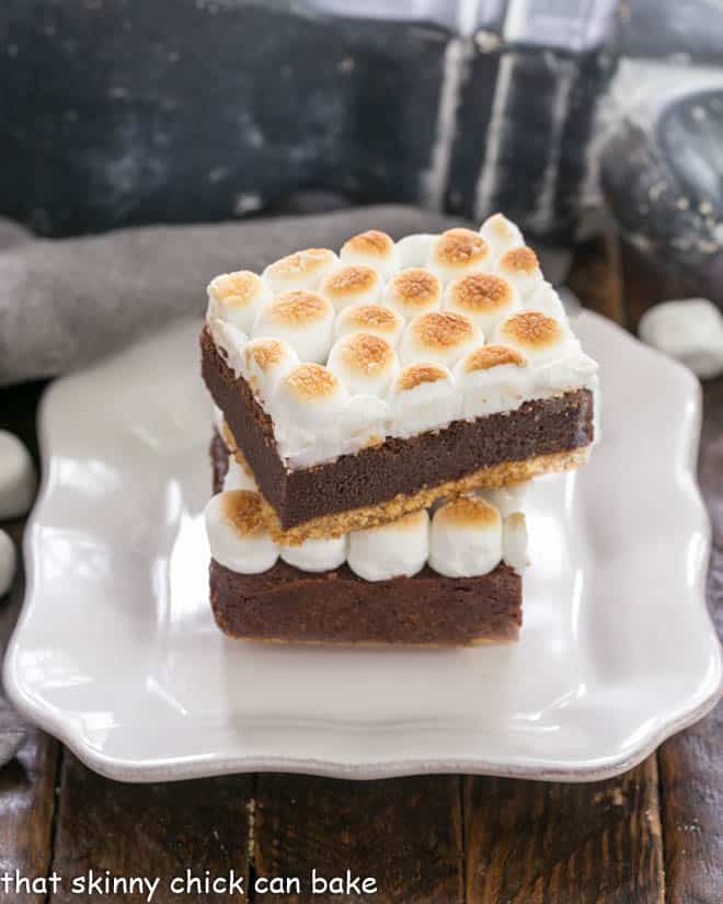 two s'mores bars stacked on a square white plate