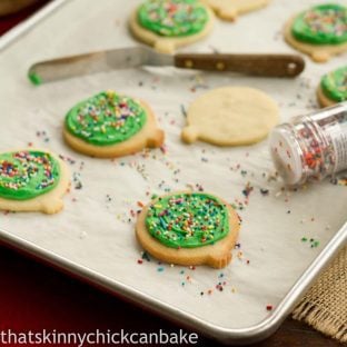 Sugar cookies on a baking sheet with sprinkles