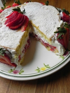 Summer strawberry cake with a slice removed