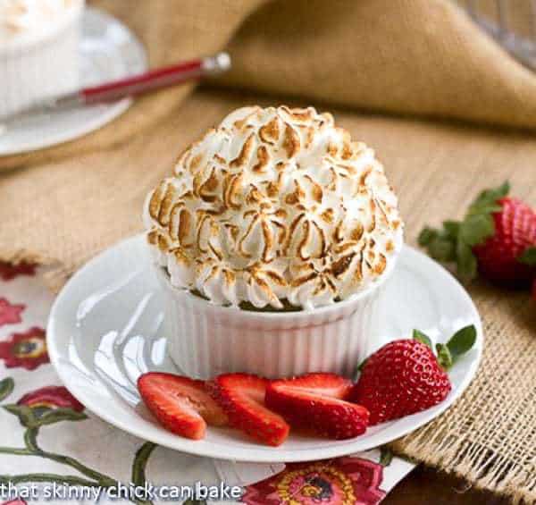 Individual Baked Alaska in a ramekin on a white saucer