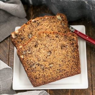 Two slices of the best banana bread on a square white plate