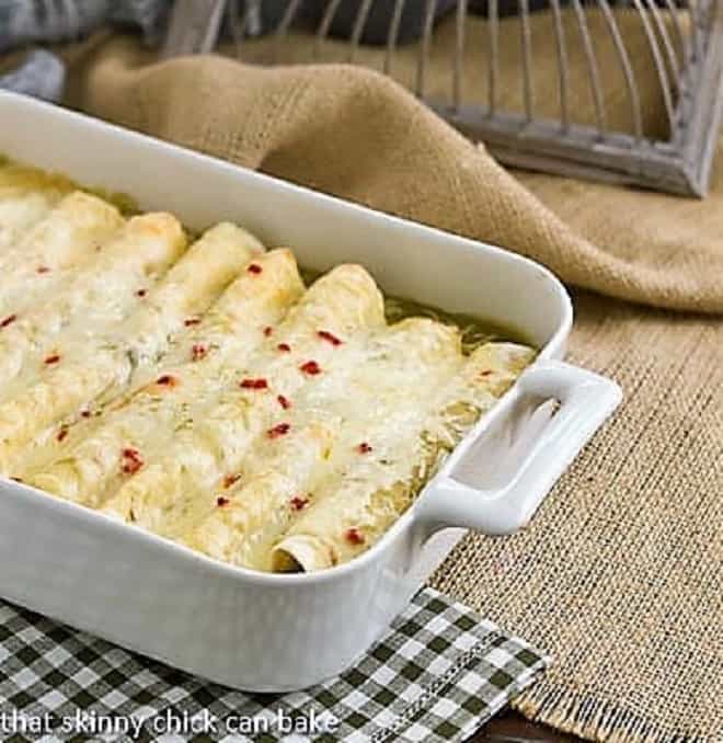 Creamy Chicken Enchiladas - an easy delicious weeknight meal! Creamy chicken enchiladas in a casserole dish