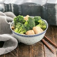 Chicken and Broccoli Stir Fry in a blue and white bowl with wooden chopsticks