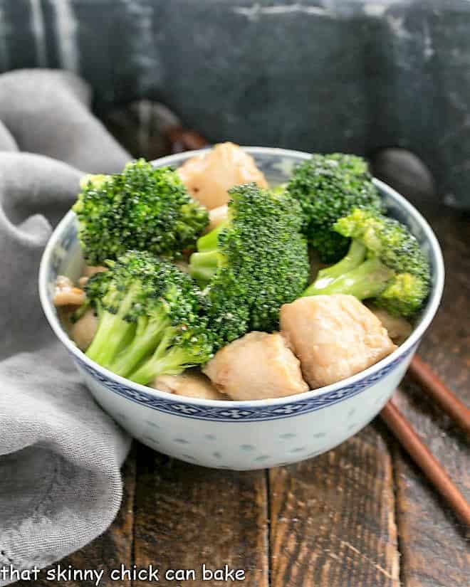broccoli and chicken in a blue and white ceramic bowl