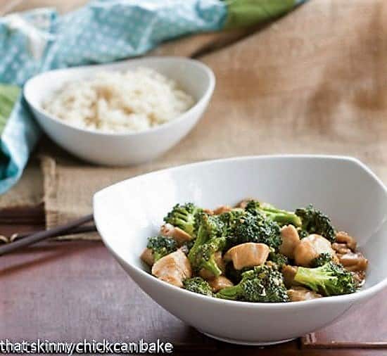 Chicken and Broccoli Stir Fry - A speedy, delicious meal with an Asian flair Chicken and Broccoli Stir Fry in a white bowl with a bowl of rice in the background