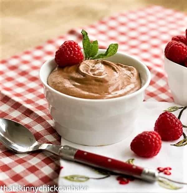 Chocolate Mousse with Grand Marnier in a white ramekin with a red handled spoon.