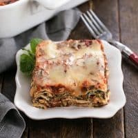 Spinach lasagna slice on a white plate