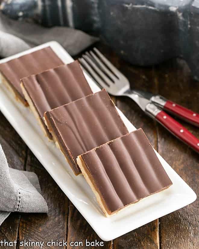 Homemade Twix Bars on a white ceramic tray