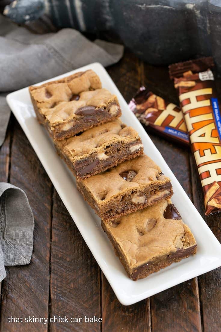 Toffee Blondies on a white tray next to Heath bars