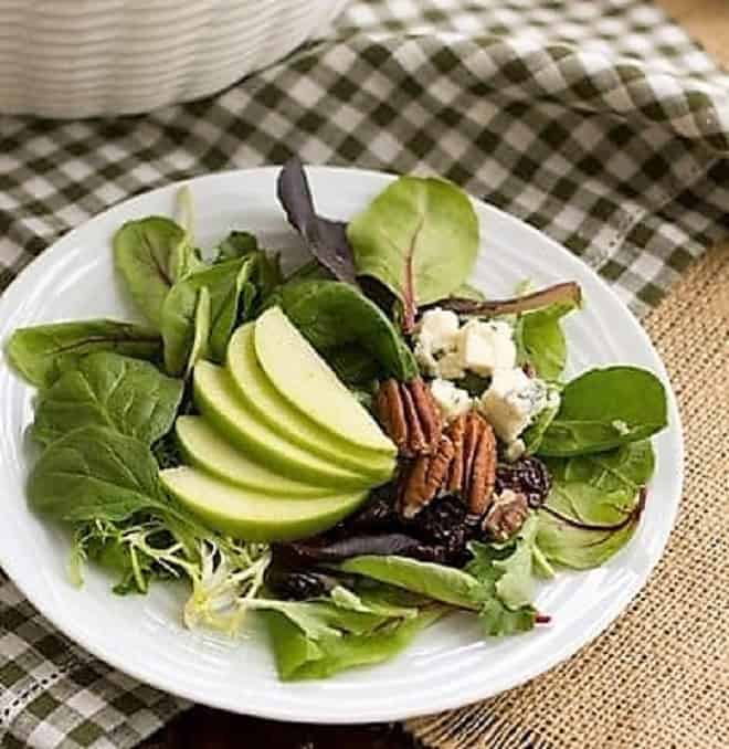 Loaded Winter Salad with Apples, Pecans, Blue Cheese and Dried Cherries on a small plate.