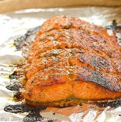 A close up of roasted Salmon on a foil lined baking sheet