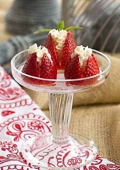 Mascarpone Filled Strawberries on a small glass pedestal