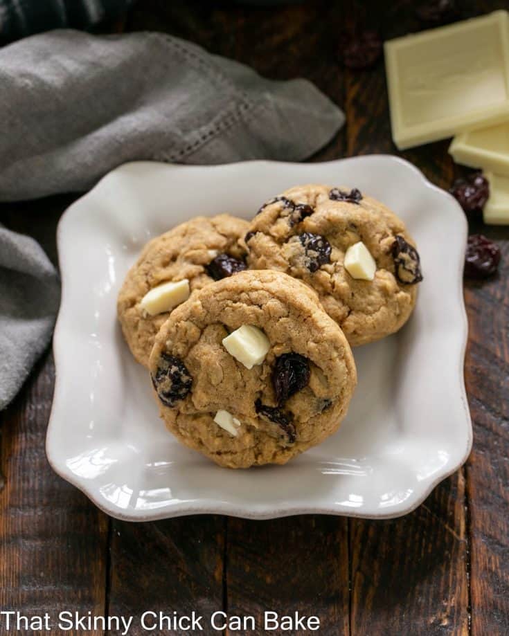 Oatmeal, Dried Cherry and White Chocolate Chunk Cookies on a square white plate