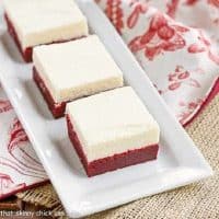 Red velvet brownies on a white tray over a red and white piece of fabric