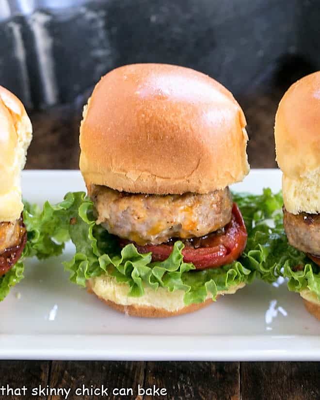 Line of turkey sliders on a white serving tray.