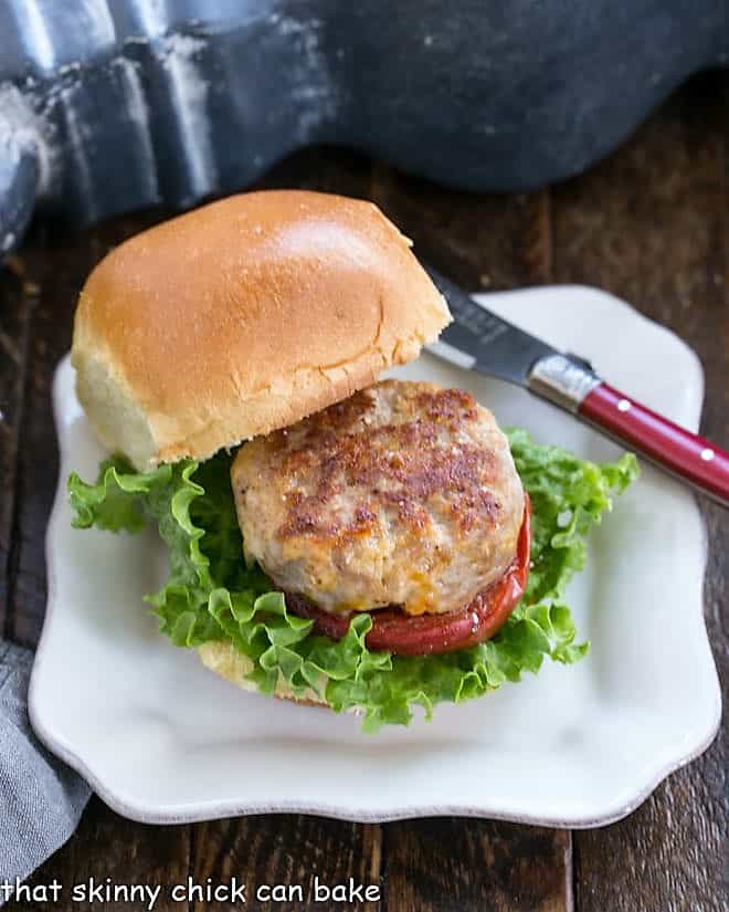 A Turkey Slider with Roasted Tomatoes on a square white plate.