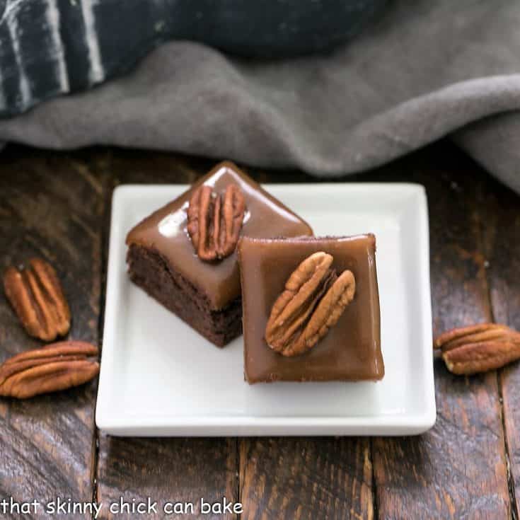 2 turtle brownies on a square white ceramic plate