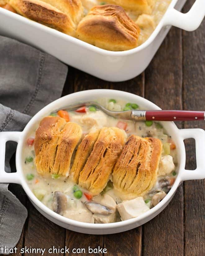 Serving of chicken pot pie in a shallow dish with a red handled fork