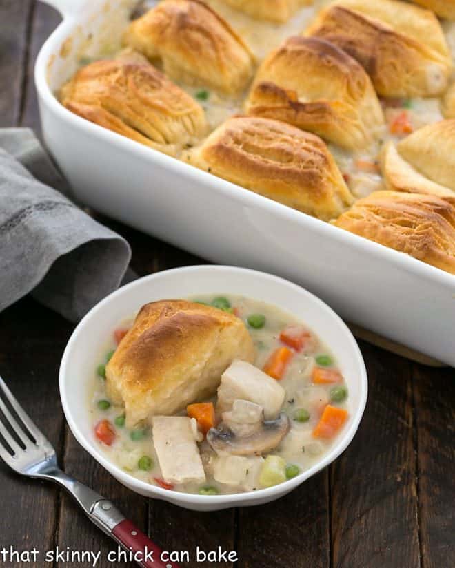 shallow bowl of chicken pot pie in front of the casserole dish