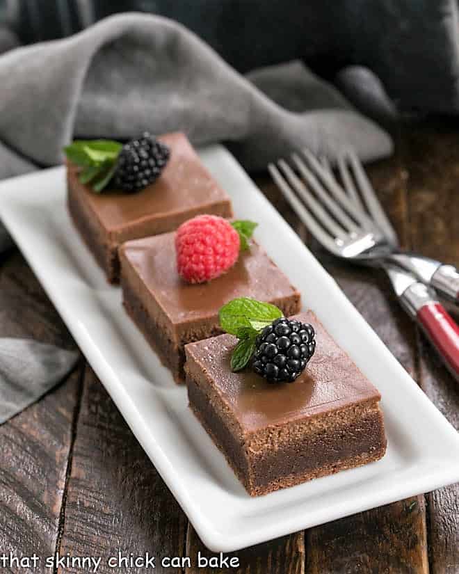 Chocolate Cheesecake Brownies on a white rectangular tray