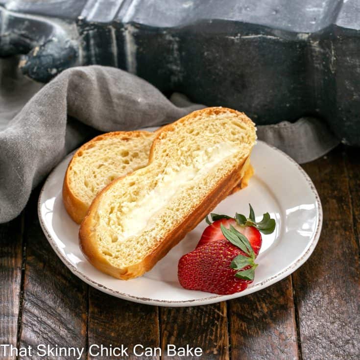 2 slices of braided Easter bread with cream cheese filling on a small white plate