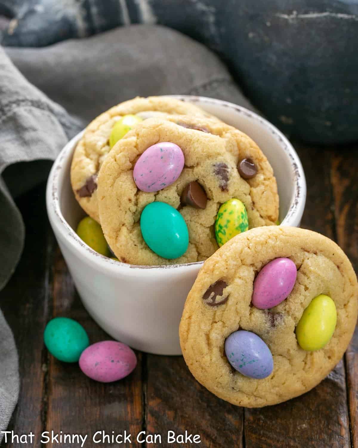 Easter cookies in a white bowl with one leaning on the bowl.