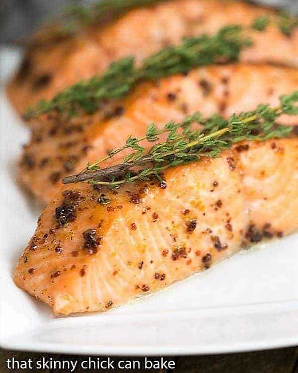 Maple Mustard Glazed Salmon fillets on a white serving tray.