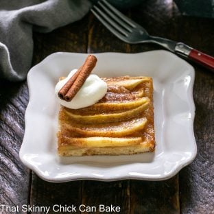 Slice of apple kuchen on a square white dessert plate