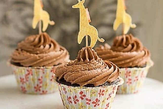 Cocoa Cupcakes with Chocolate Buttercream in floral paper wrappers with a giraffe topper