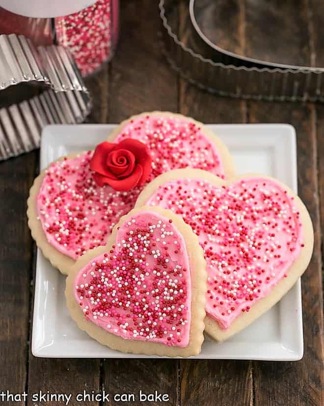 Frosted Sugar Cookies on a square white plate.