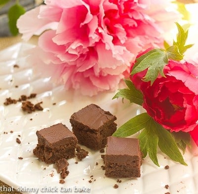 A nearly empty platter of Refrigerator Brownies with some pink peonies